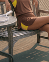 Flextra Womens Skorts - Brown & Yellow, on bench