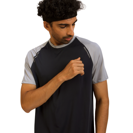 Man wearing a black and gray athletic shirt on a white background