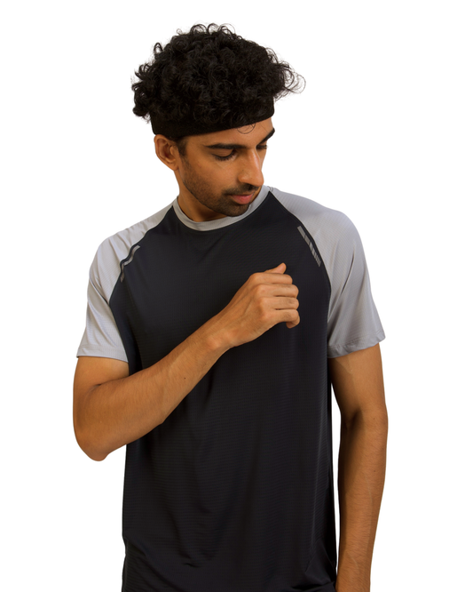 Man wearing a black and gray athletic shirt on a white background