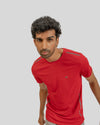 Man wearing a red athletic shirt on a gray background