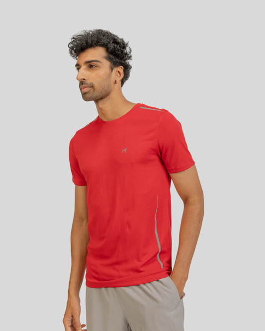 Man wearing a red athletic shirt on a light gray background