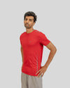 Man wearing a red athletic shirt on a gray background