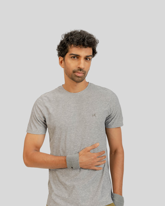 Man wearing a gray t-shirt against a plain background