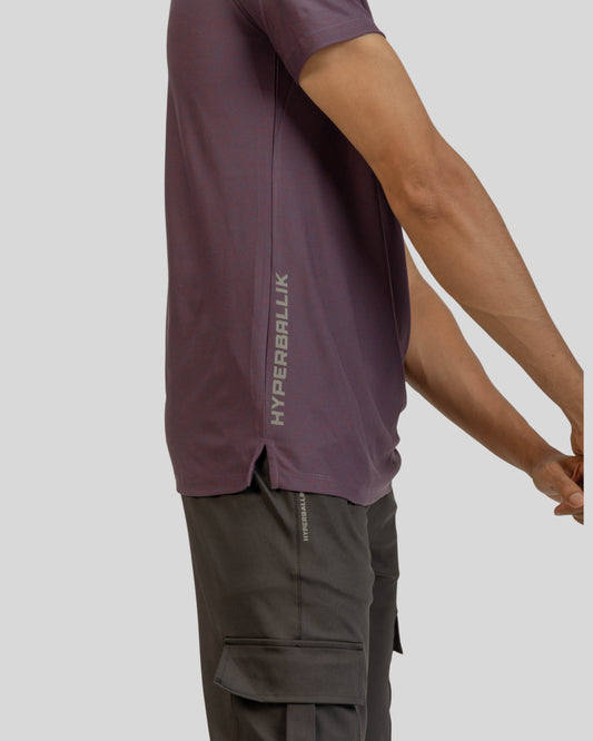 Person wearing a maroon athletic shirt with 'HYPERBALLIK' branding on a light gray background