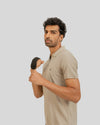 Man holding a black object against a plain background