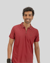 Man wearing a red polo shirt against a plain background