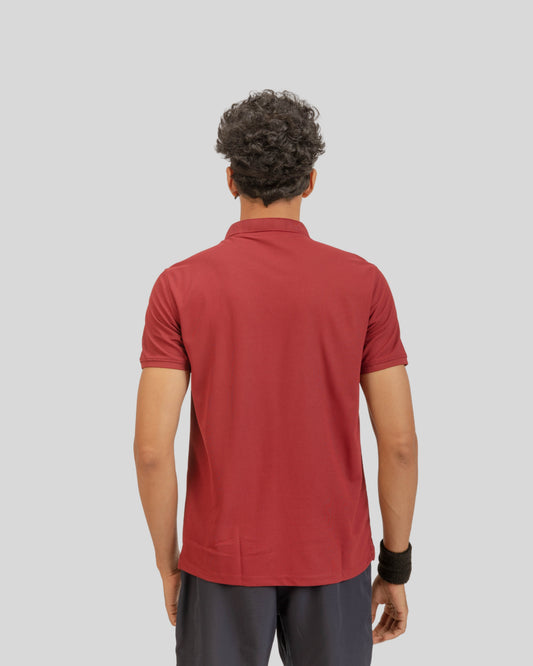 Person wearing a red polo shirt on a gray background