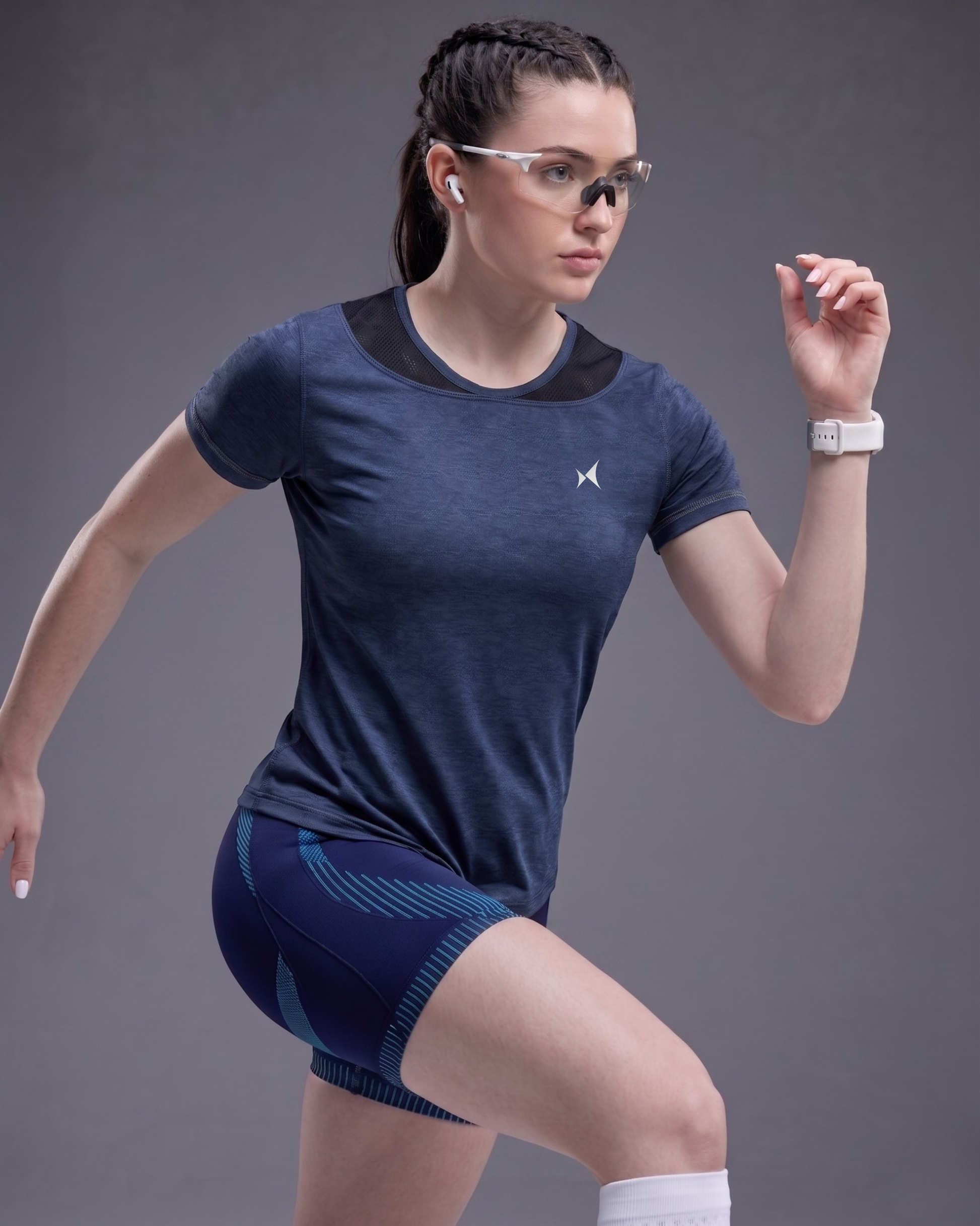 Woman in athletic wear with a gray background