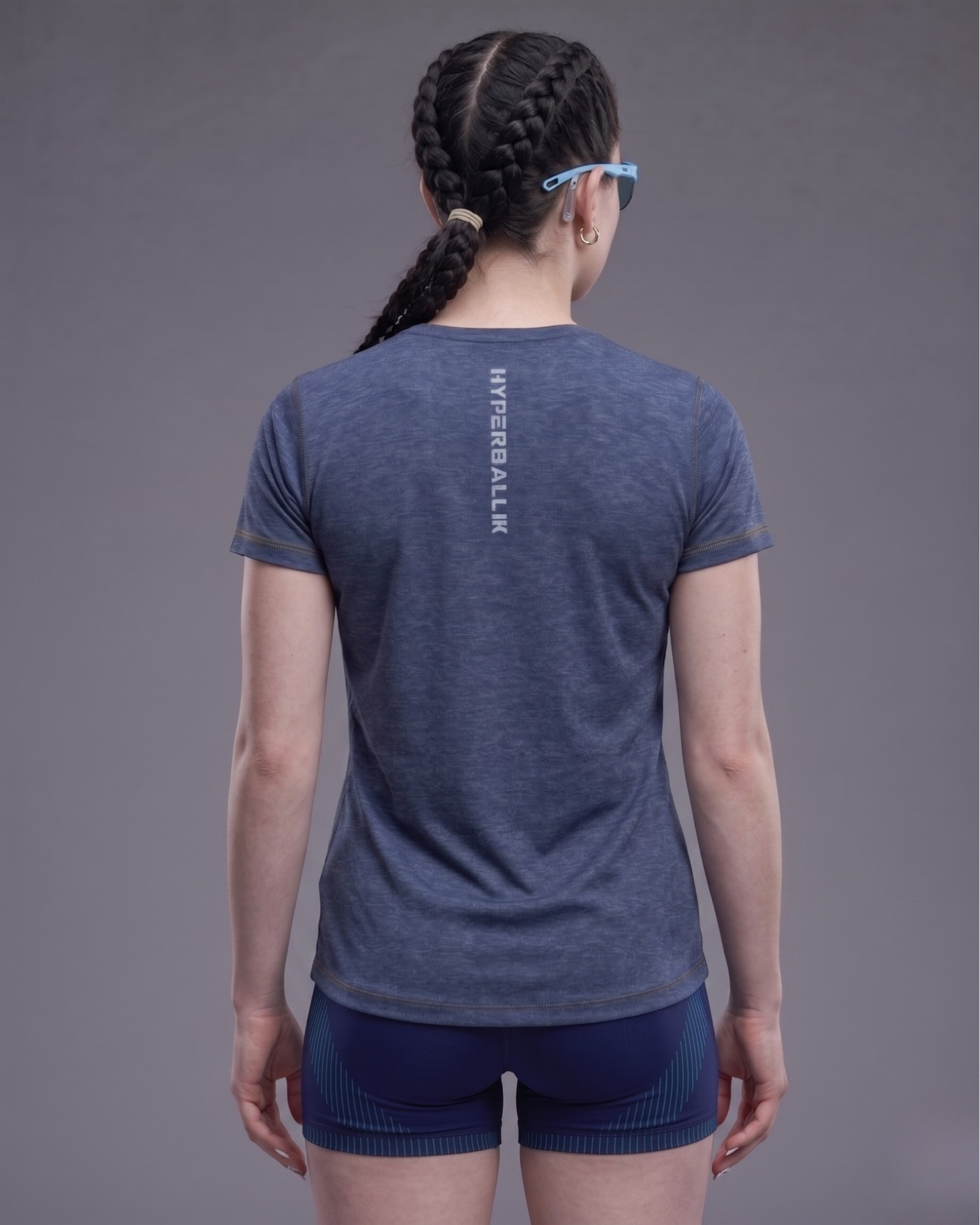 Person wearing a blue athletic shirt with 'HYPERBALL' branding on the back against a gray background