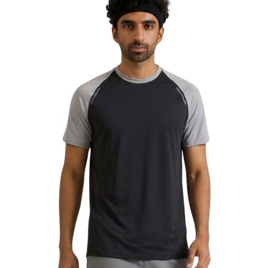 Man wearing a black and gray athletic shirt on a white background
