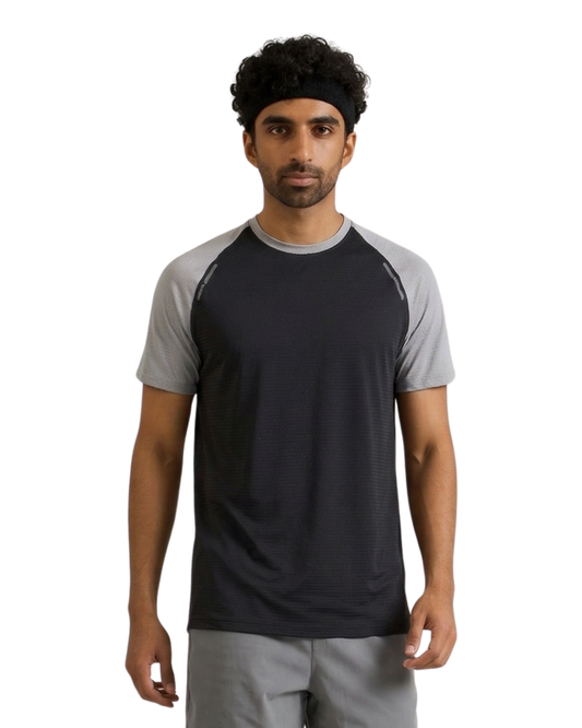 Man wearing a black and gray athletic shirt on a white background