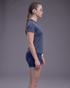 Person wearing a blue athletic outfit on a gray background