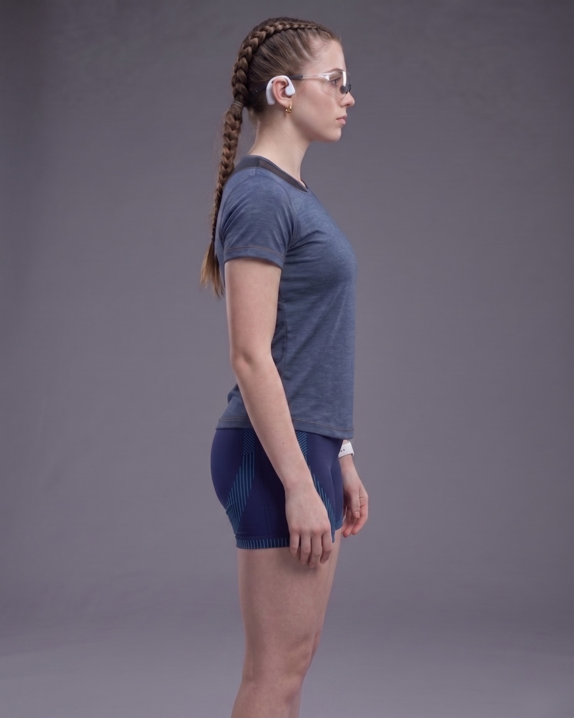 Person wearing a blue athletic outfit on a gray background