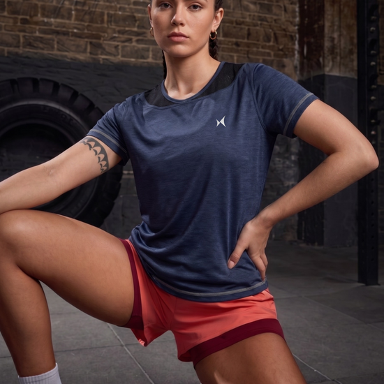 Woman in athletic wear posing in a gym setting