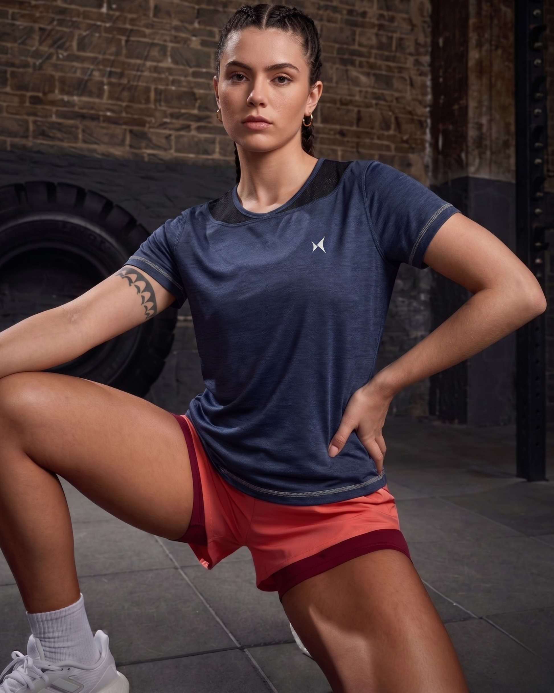 Woman in athletic wear posing in a gym setting