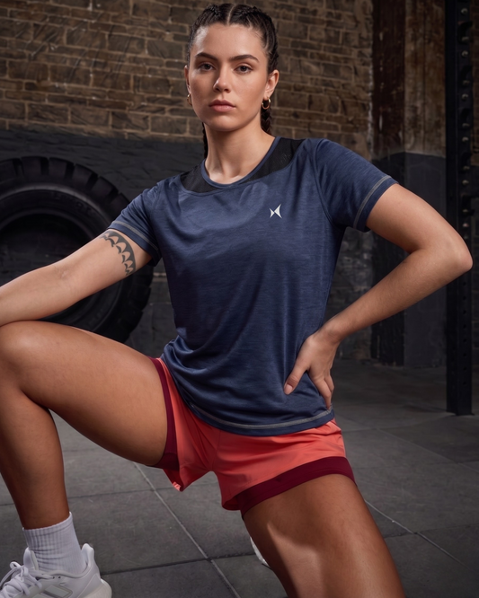 Woman in athletic wear posing in a gym setting