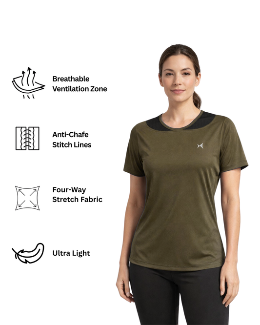 Woman wearing a green athletic shirt with a logo on a beige background