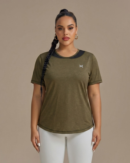 Woman wearing a green athletic shirt with a logo on a beige background