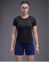 Person wearing a black athletic shirt and blue shorts on a gray background