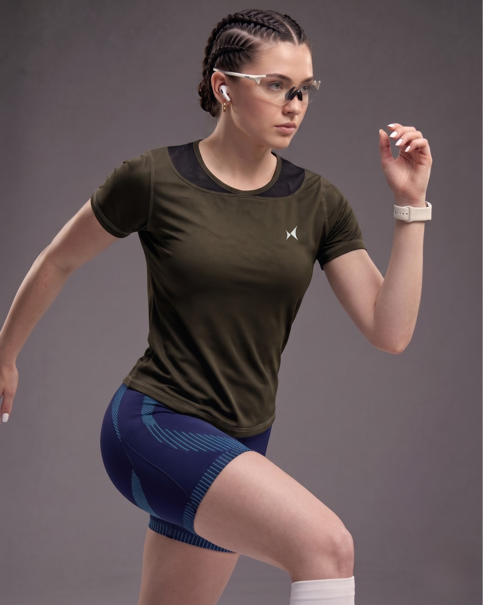Woman in athletic wear with a dark background