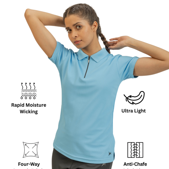 Woman wearing a light blue polo shirt with text icons indicating features like rapid moisture wicking, ultra light, four-way stretch fabric, and anti-chafe stitch lines.