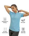 Woman wearing a light blue polo shirt with text icons indicating features like rapid moisture wicking, ultra light, four-way stretch fabric, and anti-chafe stitch lines.