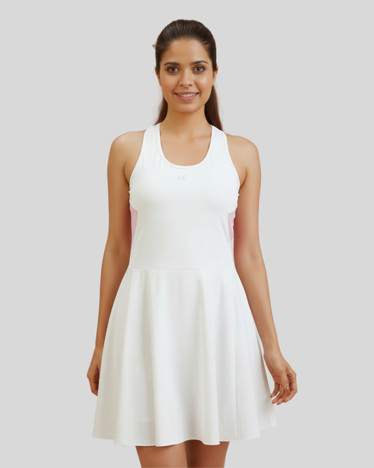 Woman wearing a white dress against a plain background