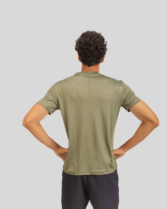Person wearing a green t-shirt on a plain background