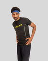 Man wearing a black athletic outfit with yellow text on a gray background