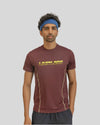 Man wearing a maroon athletic shirt with 'Limitless' text on a gray background