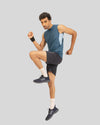 Man in athletic wear jumping in the air on a gray background