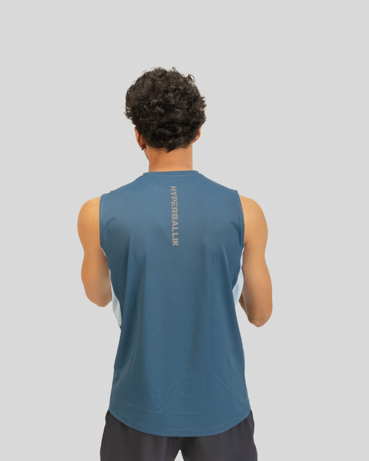 Person wearing a blue sleeveless shirt with branding on the back against a gray background