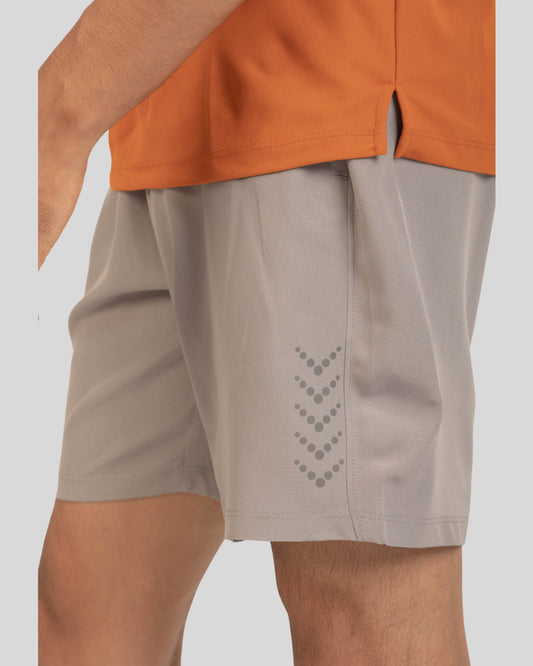 Beige shorts with a geometric pattern on a white background