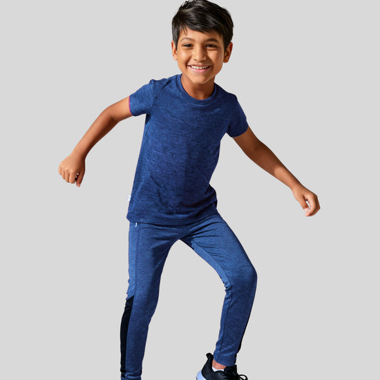 Child wearing a blue athletic outfit on a light gray background