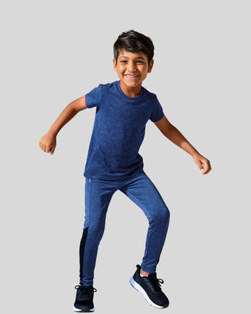 Child wearing a blue athletic outfit on a light gray background