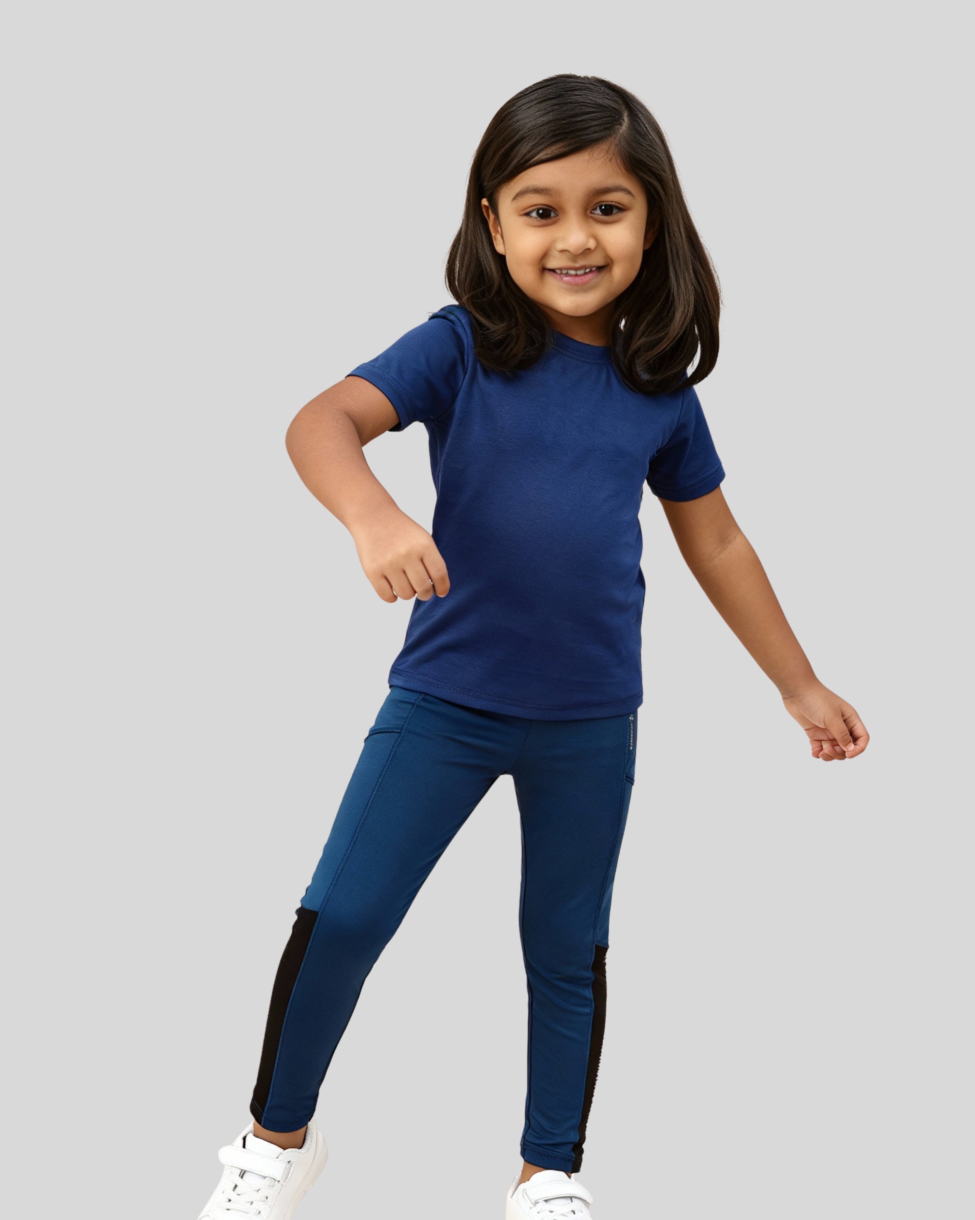 Child wearing a blue outfit with black accents on a gray background
