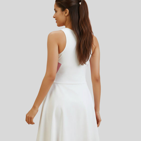 Woman wearing a white dress on a plain background