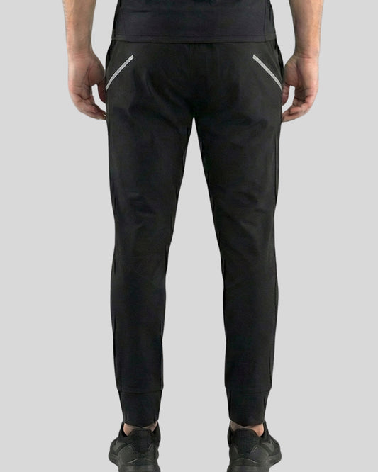 Black pants with reflective stripes on a gray background