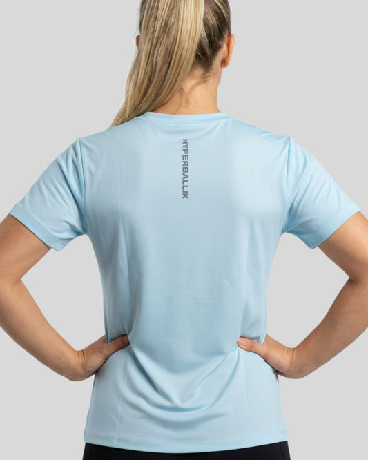 Person wearing a light blue t-shirt with 'HYPERBALLISTIK' branding on the back, standing against a plain background.