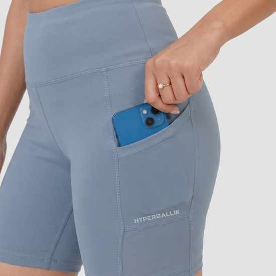  blue athletic shorts with a pocket holding a phone