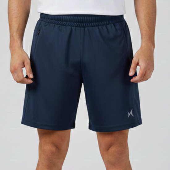 Person wearing navy shorts with a brand logo on a light gray background