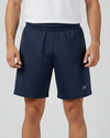Person wearing navy shorts with a brand logo on a light gray background