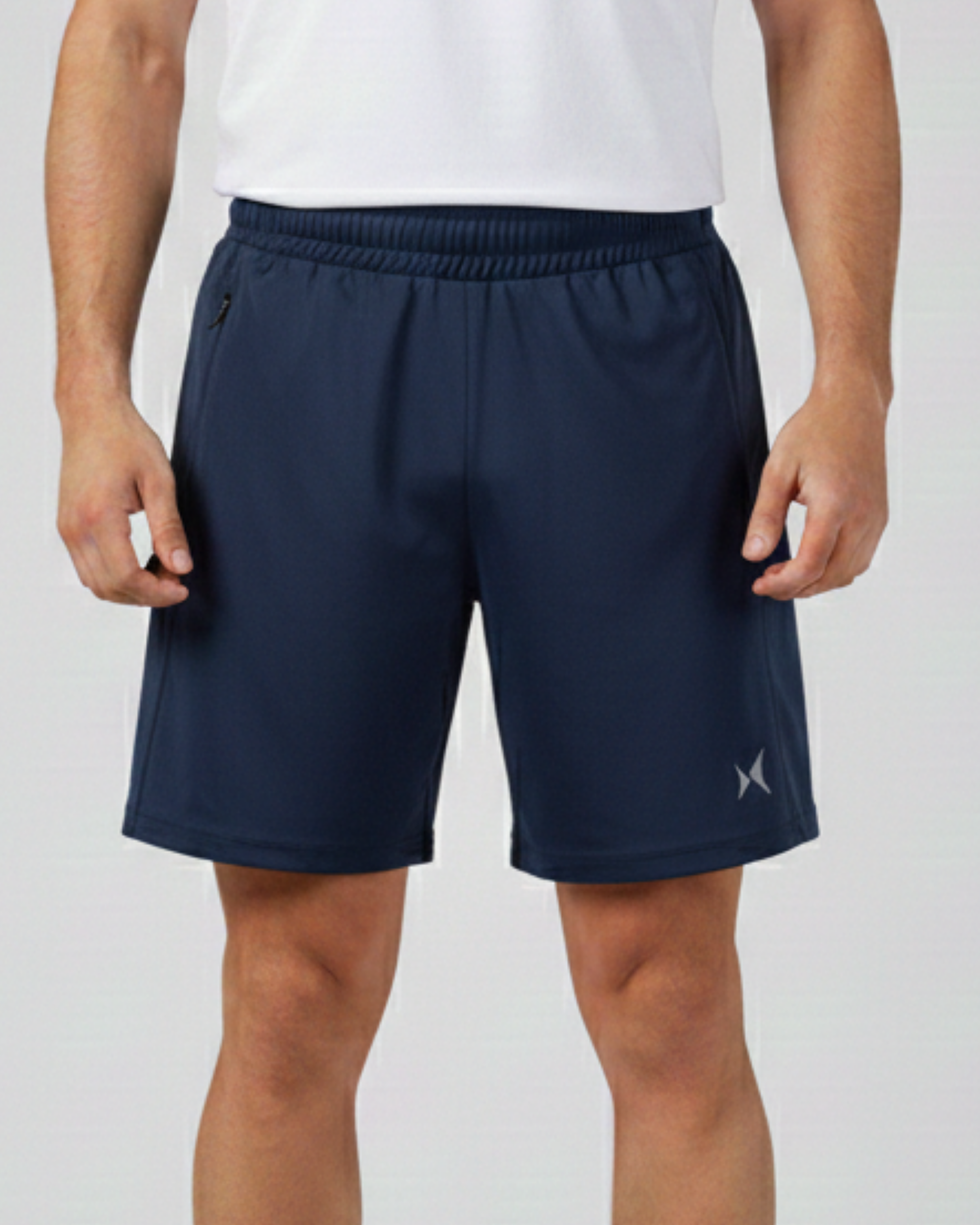Person wearing navy shorts with a brand logo on a light gray background
