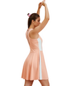 Woman wearing a peach dress with a white stripe on a white background