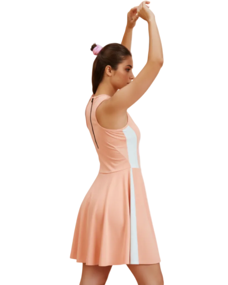 Woman wearing a peach dress with a white stripe on a white background