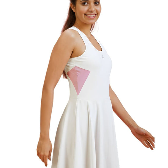 Woman wearing a white dress with pink accents on a white background