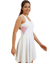 Woman wearing a white dress with pink accents on a white background