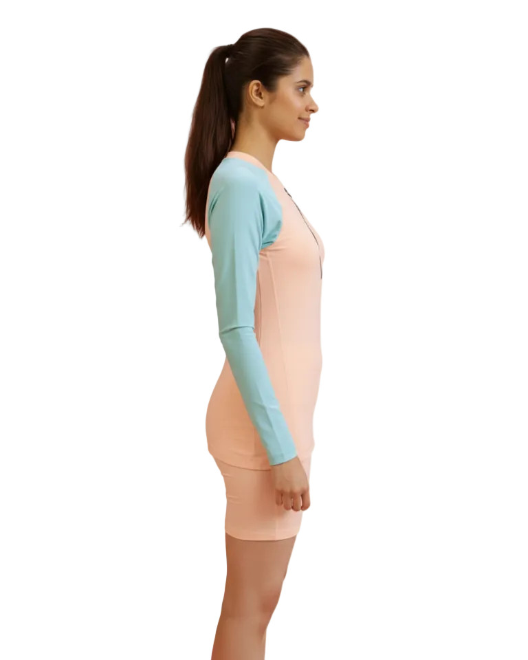 Woman wearing a light blue long-sleeve top and beige leggings on a white background