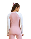 Woman wearing a pink and white long-sleeve top on a white background