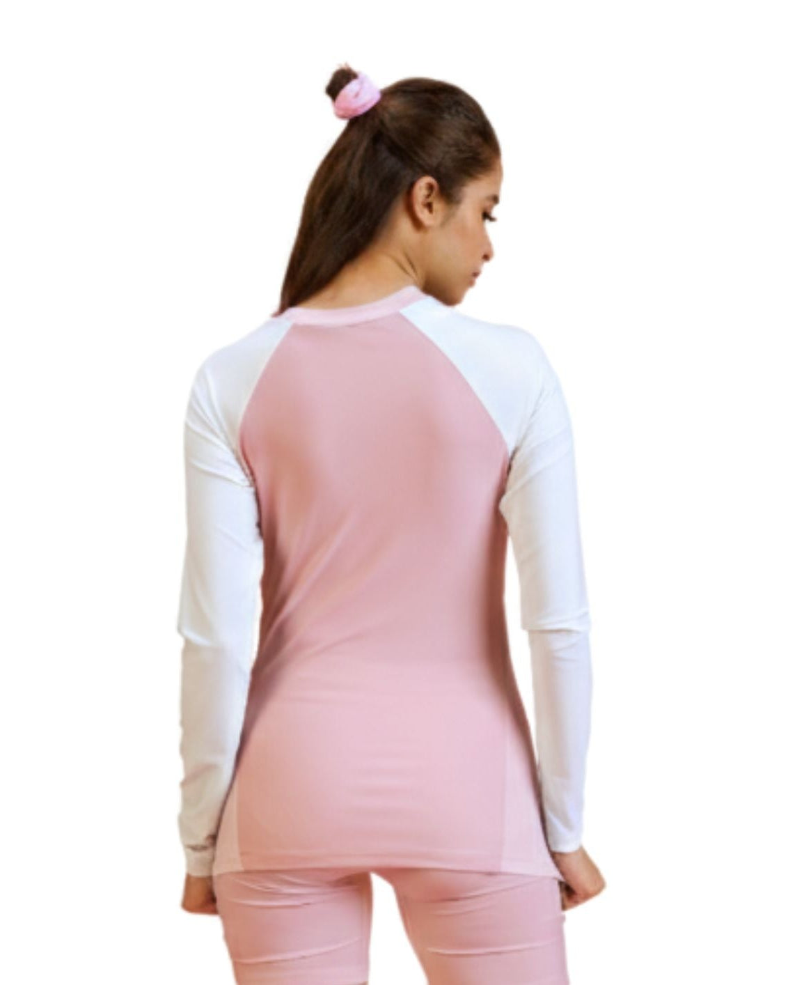 Woman wearing a pink and white long-sleeve top on a white background